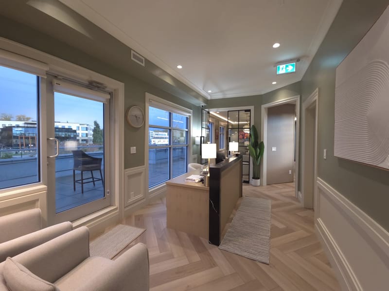 Reception desk and entrance at the EverStone CPA accounting office in Abbotsford, BC, with herringbone flooring and windows onto South Fraser Way