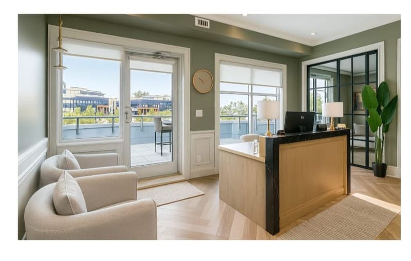 Seating area beside the reception desk at EverStone CPA in Abbotsford, BC, with armchairs and a door to the terrace